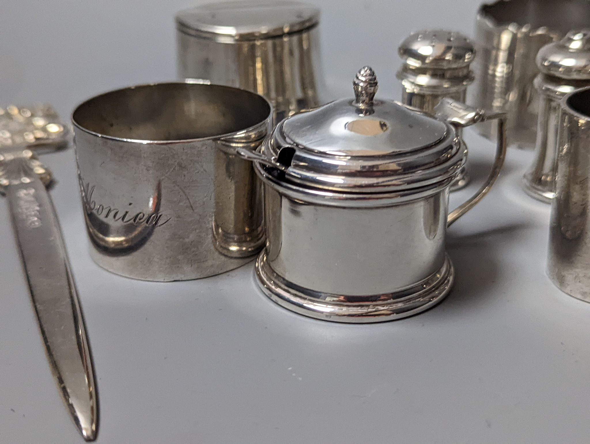 A modern Queens' Silver Jubilee commemorative silver paper knife, 16.9cm, London, 1977, a silver inkwell, three silver napkin rings and three silver condiments.